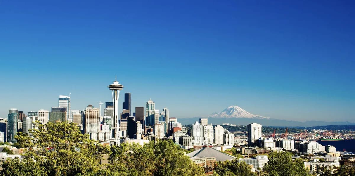 Kerry Park view from Queen Anne — Space Needle in front of downtown Seattle with Mount Rainier rising in the distance